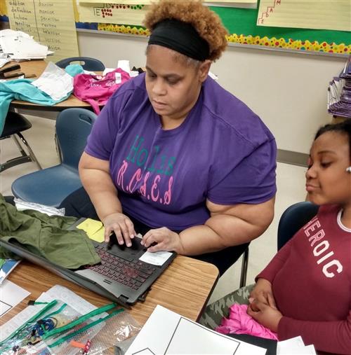 Teacher works with students to make shirts 